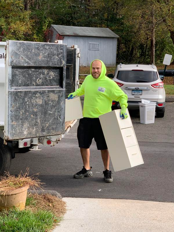 A photo of James loading a file cabinet in NJR's truck